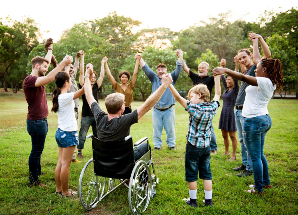 Group of people holding hand together in the park